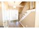 Inviting foyer with hardwood floors, staircase, and stylish lighting fixture at 235 Woodstream Way, Fayetteville, GA 30214
