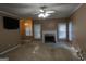 Spacious living room featuring neutral carpet, a classic fireplace, and bright natural light at 235 Woodstream Way, Fayetteville, GA 30214