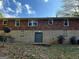 View of the rear of the house with brick and cement block and basement access at 1858 Sahara Se Dr, Atlanta, GA 30316