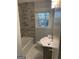Updated bathroom featuring marble tiling, a tub-shower, and a modern vanity with a sink and chrome fixtures at 1858 Sahara Se Dr, Atlanta, GA 30316