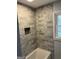 Updated bathroom featuring marble tile shower and window allowing natural light at 1858 Sahara Se Dr, Atlanta, GA 30316