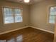 Bedroom with hardwood floors, two windows with blinds, and neutral colored walls at 1858 Sahara Se Dr, Atlanta, GA 30316