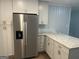 Kitchen featuring stainless steel refrigerator, white cabinets, and granite countertops at 1858 Sahara Se Dr, Atlanta, GA 30316