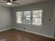 Bright and airy living room with hardwood floors, a ceiling fan, and a wall of windows with blinds at 1858 Sahara Se Dr, Atlanta, GA 30316