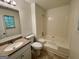 A neutral bathroom with granite counters, tiled floors and a tub and shower combo at 6026 Woodcreek Dr, Woodstock, GA 30188