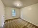 This carpeted bedroom has a single window, overhead lighting and neutral paint at 6026 Woodcreek Dr, Woodstock, GA 30188