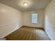 Neutral bedroom with carpet and white trim. Single window lets in natural light at 6026 Woodcreek Dr, Woodstock, GA 30188