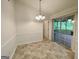 Bright dining area with a sliding door to the screened-in porch, and neutral paint and flooring at 6026 Woodcreek Dr, Woodstock, GA 30188