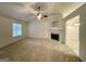 Bright living room with a ceiling fan and a white fireplace, creating a cozy atmosphere at 6026 Woodcreek Dr, Woodstock, GA 30188