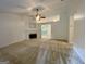 Spacious living room with a cozy fireplace and neutral carpet, creating a warm atmosphere at 6026 Woodcreek Dr, Woodstock, GA 30188
