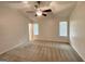 The carpeted main bedroom has a ceiling fan and two windows for lots of light at 6026 Woodcreek Dr, Woodstock, GA 30188