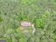 Aerial view displaying a home secluded within a dense, lush forest setting at 428 Turner Rd, Mcdonough, GA 30252