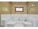 Bathroom with large garden tub, neutral walls, and decorative stained glass window at 428 Turner Rd, Mcdonough, GA 30252