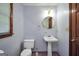 Cozy half bathroom with pedestal sink, mirror, and wooden accents at 428 Turner Rd, Mcdonough, GA 30252