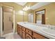 Bathroom with a long vanity, double sinks, and a separate shower with a glass door at 428 Turner Rd, Mcdonough, GA 30252
