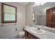 Bathroom with a white sink, toilet, and a window for natural light at 428 Turner Rd, Mcdonough, GA 30252