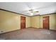 Spacious bedroom with neutral walls, carpet, two closets, and a ceiling fan at 428 Turner Rd, Mcdonough, GA 30252