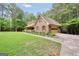 Brick home with dormers, attached garage, and a manicured lawn at 428 Turner Rd, Mcdonough, GA 30252