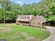 A yellow brick home with dormers, an attached garage and a big lawn at 428 Turner Rd, Mcdonough, GA 30252