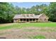 Charming one-story brick home featuring a welcoming front porch and mature trees in the front yard at 428 Turner Rd, Mcdonough, GA 30252