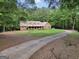 A brick home with a long, curved driveway, and large front lawn at 428 Turner Rd, Mcdonough, GA 30252