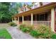Inviting front porch with brickwork and colorful trim, perfect for enjoying the outdoors at 428 Turner Rd, Mcdonough, GA 30252