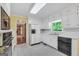 Kitchen with a classic layout featuring white cabinetry and appliances, with an adjoining dining area at 428 Turner Rd, Mcdonough, GA 30252