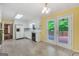 Bright kitchen with tile floors, white cabinetry, and a view of the wooded backyard at 428 Turner Rd, Mcdonough, GA 30252