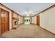 Living area with brick fireplace, carpet flooring, and open access to additional rooms at 428 Turner Rd, Mcdonough, GA 30252