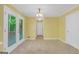 Bright living room with tile flooring, yellow walls, and double glass doors to the outside deck at 428 Turner Rd, Mcdonough, GA 30252