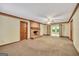 Open living room with brick fireplace, carpeted flooring, and connecting rooms through wood-framed doorways at 428 Turner Rd, Mcdonough, GA 30252