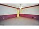 Empty room with wallpaper and wood trim, carpeted, and an open doorway into the adjacent room at 428 Turner Rd, Mcdonough, GA 30252