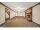 Spacious living room features a brick fireplace, ceiling fan, neutral walls, and carpet at 428 Turner Rd, Mcdonough, GA 30252