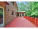 Spacious red deck, offering a great outdoor living space with views of the wooded backyard at 428 Turner Rd, Mcdonough, GA 30252