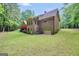 Back of home with a red deck on the second story, green lawn, and access to the garage at 428 Turner Rd, Mcdonough, GA 30252