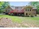 Large red deck with a lush green lawn, perfect for entertaining and outdoor enjoyment at 428 Turner Rd, Mcdonough, GA 30252