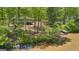 Aerial view of property with home, dock, and wooded area surrounding the pond at 679 Bo Bo Banks Rd, Grantville, GA 30220