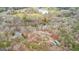Aerial view showcasing the property with multiple dwellings surrounded by a lush forest and a serene pond at 679 Bo Bo Banks Rd, Grantville, GA 30220