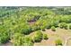 Expansive aerial view of wooded land with a small pond and open fields, perfect for nature enthusiasts at 679 Bo Bo Banks Rd, Grantville, GA 30220