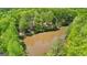 An aerial view of a lush forest with a pond and a boat dock at 679 Bo Bo Banks Rd, Grantville, GA 30220