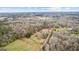 Scenic aerial view of property featuring land, pond, trees, and driveway at 679 Bo Bo Banks Rd, Grantville, GA 30220