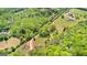 A gorgeous aerial view of a home nestled in a green, luscious forest with a long driveway at 679 Bo Bo Banks Rd, Grantville, GA 30220