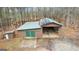 Large barn featuring a metal roof, green doors, storage, and solar panels to generate power at 679 Bo Bo Banks Rd, Grantville, GA 30220