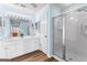 A bathroom featuring a double vanity with a bright mirror and lighting as well as a glass shower at 679 Bo Bo Banks Rd, Grantville, GA 30220