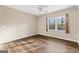 The bedroom has luxury vinyl floors, a ceiling fan, and a window with wooded views at 679 Bo Bo Banks Rd, Grantville, GA 30220