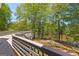 View from deck overlooking tranquil pond surrounded by lush trees offering a serene outdoor retreat at 679 Bo Bo Banks Rd, Grantville, GA 30220