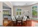 Dining area with fireplace, hardwood floors, and access to an outdoor deck at 679 Bo Bo Banks Rd, Grantville, GA 30220