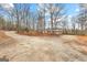 Spacious driveway leads to the house surrounded by trees, perfect for extra parking at 679 Bo Bo Banks Rd, Grantville, GA 30220
