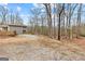 Rustic home surrounded by trees and gravel driveway, perfect for nature lovers and privacy at 679 Bo Bo Banks Rd, Grantville, GA 30220