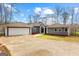 Charming one-story home with well-manicured landscaping, gray siding, and attached garage at 679 Bo Bo Banks Rd, Grantville, GA 30220